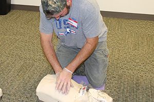 A Benson employee practices on a CPR dummy