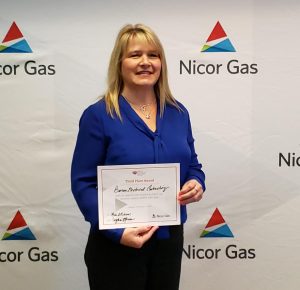 Vickie Marconi holds her Nicor "Pitch Perfect Presentation" Award